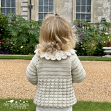 child showing the back of a crocheted cardigan