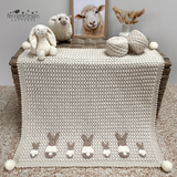 Bunny appliques sewn on a baby blanket crochet pattern 