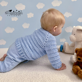 Baby crawling in a chunky jumper 
