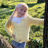 Yellow bow jumper on a child 