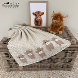 Highland cow blanket spread out on a wicker trunk