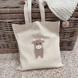 A highland cow applique sewn onto a tote bag 