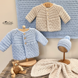 A display of crochet cardigans, hat and blanket 