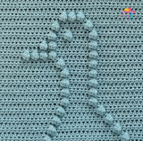 A close up of the goose head in texured bobbles 