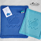 A blue and turquoise whale blanket 