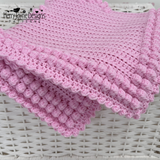 A pink crocheted blanket border