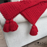 Red blanket with tassels