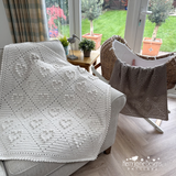Crocheted throw blanket with hearts on