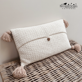 Crocheted cushion with four tassels and a button closure at the back, a crochet pattern by Kerry Jayne Designs 